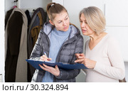 Female caseworker conducting survey. Стоковое фото, фотограф Яков Филимонов / Фотобанк Лори