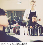 Client looking displeased about new haircut. Стоковое фото, фотограф Яков Филимонов / Фотобанк Лори