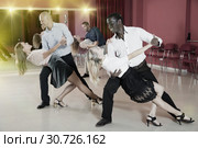 Adult pairs dancing tango movements in modern dance studio. Стоковое фото, фотограф Яков Филимонов / Фотобанк Лори