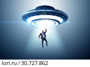 Flying saucer abducting young businessman. Стоковое фото, фотограф Elnur / Фотобанк Лори