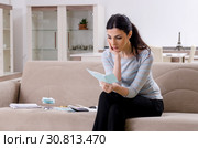 Young woman in budget planning concept. Стоковое фото, фотограф Elnur / Фотобанк Лори