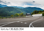 A view of a curved road. Driving a car on mountain road. Asphalt road in mountain. Empty road background. Стоковое фото, фотограф Андрей Холмов / Фотобанк Лори