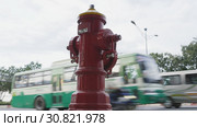 Red fire hydrant poles on street Ho Chi Minh city. Next to the road and passing cars and motorcycles. Vietnam. Редакционное фото, фотограф Mikhail Davidovich / Фотобанк Лори