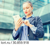 Female testing digital tablet in the modern city. Стоковое фото, фотограф Яков Филимонов / Фотобанк Лори