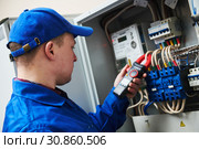 Electrician work concept. Hand with multimeter tester in switchbox. Стоковое фото, фотограф Дмитрий Калиновский / Фотобанк Лори