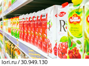 Russia Samara June 2019: a large selection of different juices and nectars in tetrapacks on the supermarket shelf. Text in Russian: Ribbon, nectar, cherry. Редакционное фото, фотограф Акиньшин Владимир / Фотобанк Лори