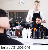 Client looking displeased about new haircut. Стоковое фото, фотограф Яков Филимонов / Фотобанк Лори
