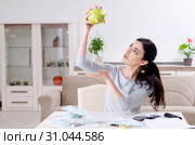 Young woman in budget planning concept. Стоковое фото, фотограф Elnur / Фотобанк Лори