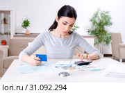 Young woman in budget planning concept. Стоковое фото, фотограф Elnur / Фотобанк Лори