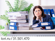 Middle-aged businesswoman unhappy with excessive work. Стоковое фото, фотограф Elnur / Фотобанк Лори