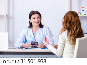 Young pregnant woman visiting experienced doctor gynecologist. Стоковое фото, фотограф Elnur / Фотобанк Лори
