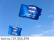 Флаги партии "Единая Россия" на фоне ясного синего неба (2019 год). Редакционное фото, фотограф Ekaterina M / Фотобанк Лори