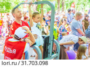 Russia Samara June 2019: a girl passes the standards for pulling up on a horizontal bar in the park sunny day. Text in Russian: Judge Gto. Редакционное фото, фотограф Акиньшин Владимир / Фотобанк Лори