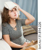 Woman with wet towel on her forehead. Стоковое фото, фотограф Яков Филимонов / Фотобанк Лори