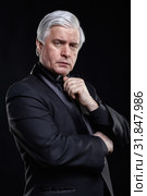 Mature man in black suit looking at the camera with a hypnotic look. Стоковое фото, фотограф Сергей Пристяжнюк (Serg Zastavkin) / Фотобанк Лори