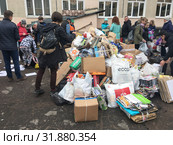 ST. PETERSBURG, RUSSIA-CIRCA MAY, 2019: Pupils of primary school and students of secondary school bring wastepaper for recycling. Scrap paper collection for utilization is in Russian school. Редакционное фото, фотограф Кекяляйнен Андрей / Фотобанк Лори