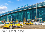 Стоянка автомобилей такси перед зданием аэровокзала Московского международного аэропорта Домодедово имени М.В. Ломоносова (2019 год). Редакционное фото, фотограф Владимир Сергеев / Фотобанк Лори