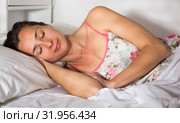 Cute adult woman in pygamas sleeping in bed in bedroom. Стоковое фото, фотограф Яков Филимонов / Фотобанк Лори