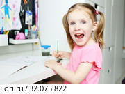 Funny lovely little girl painting. Стоковое фото, фотограф ivolodina / Фотобанк Лори