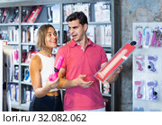 woman and man bayers choosing long rubber phallus in the sex shop. Стоковое фото, фотограф Яков Филимонов / Фотобанк Лори