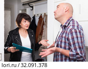 Woman conducting survey among people at door. Стоковое фото, фотограф Яков Филимонов / Фотобанк Лори