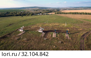 Добыча нефти. Куст станков-качалок. Вид с воздуха. Oil production. A group of pumpjacks. Aerial view. Стоковое фото, фотограф Евгений Романов / Фотобанк Лори