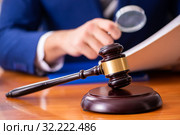 Young male judge sitting in courtroom. Стоковое фото, фотограф Elnur / Фотобанк Лори