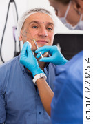 Female doctor is doing injection to patient in skin of face. Стоковое фото, фотограф Яков Филимонов / Фотобанк Лори