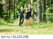 man and woman jogging and running outdoors in forest. Стоковое фото, фотограф Дмитрий Калиновский / Фотобанк Лори