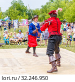 Russia, Samara, June 2016: A battle of musketeers on swords for the audience of the festival "Journey to the Past", which takes place near Samara on a sunny summer day. Редакционное фото, фотограф Акиньшин Владимир / Фотобанк Лори