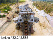 Old rusty multi bucket excavator, giant stacker, absetzer in sandy career. Стоковое фото, фотограф Mikhail Starodubov / Фотобанк Лори