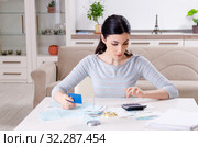 Young woman in budget planning concept. Стоковое фото, фотограф Elnur / Фотобанк Лори