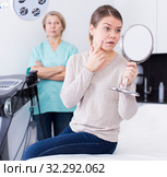 Female unpleasantly surprised with results of cosmetic procedures. Стоковое фото, фотограф Яков Филимонов / Фотобанк Лори