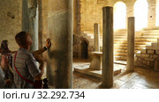 tourists touch the columns in the holy church of St. Nicholas the Wonderworker and are baptized (2019 год). Редакционное видео, видеограф Aleksandr Sulimov / Фотобанк Лори