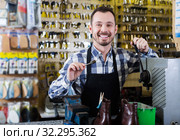 Worker demonstrating newly shaped key. Стоковое фото, фотограф Яков Филимонов / Фотобанк Лори