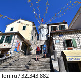 Herceg Novi, Montenegro - June 10. 2019. The area of the old city. View of the clock tower of Sat Kula. Редакционное фото, фотограф Володина Ольга / Фотобанк Лори
