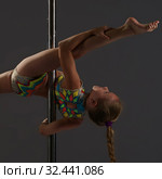Adorable little girl exercising on pylon in studio. Стоковое фото, фотограф Гурьянов Андрей / Фотобанк Лори