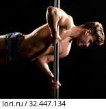 Studio photo of handsome guy dancing on pylon. Стоковое фото, фотограф Гурьянов Андрей / Фотобанк Лори