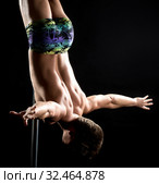 Male pole dance. Guy posing upside down on pylon. Стоковое фото, фотограф Гурьянов Андрей / Фотобанк Лори