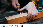 Carpentry industry - a woodworker cutting out the recess on the wooden block with a chisel. Стоковое видео, видеограф Константин Шишкин / Фотобанк Лори