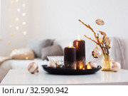 black burning candles with Christmas balls in white interior. Стоковое фото, фотограф Майя Крученкова / Фотобанк Лори