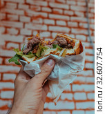 Tasty Hamburger with ham and salad in the man's hand. Стоковое фото, фотограф Aleksejs Bergmanis / Фотобанк Лори