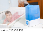 Blue and white humidifier in use. Air humidification for baby comfort sleeping. Стоковое фото, фотограф Кекяляйнен Андрей / Фотобанк Лори