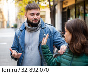 Woman stopping man bothering her on street. Стоковое фото, фотограф Яков Филимонов / Фотобанк Лори