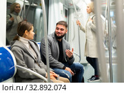 Portrait of playful positive people making acquaintance in public transport. Стоковое фото, фотограф Яков Филимонов / Фотобанк Лори