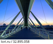 Современный пешеходный мост в Беер Шеве  в сумерках на фоне города (2019 год). Редакционное фото, фотограф Irina Opachevsky / Фотобанк Лори