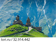 Georgia, Trinity Church on the mountain against the background of rocks in the village of Gergeti on the Georgian Military Highway. Стоковое фото, фотограф Константин Лабунский / Фотобанк Лори