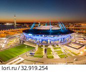 Saint Petersburg, Russia - August 29, 2019: Night Aerial panoramic view of Zenit Arena with illumination. New football Stadium for the FIFA Soccer World Cup 2018. photo from quadrocopter drone flight. Редакционное фото, фотограф Алексей Ширманов / Фотобанк Лори