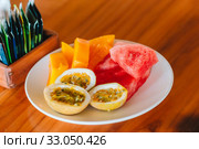 Tasty exotic fruits - ripe passion fruit, mango on breakfast at outdoor restaraunt. Стоковое фото, фотограф Дмитрий Травников / Фотобанк Лори