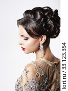Profile of Classy Brown Hair Lady with Jewelry and Festive Hairstyle. Стоковое фото, фотограф Iryna Hramavataya / PantherMedia / Фотобанк Лори